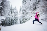 Woman doing yoga in a snowy landscape