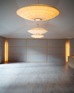 Empty room with large ceiling lamps