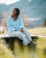 Woman sitting on a wooden bridge
