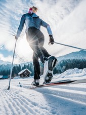 Woman cross-country skiing in a wintry landscape