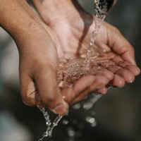 Water splashes into hands