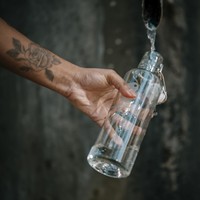 Person fills up water bottle at the water dispenser