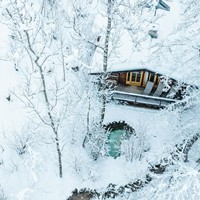 Wooden hut in the snowy forest