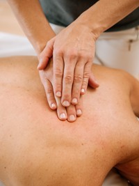 Experience gentle relaxation with a spa treatment Hands massaging a person's back