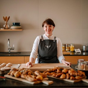 Woman in the kitchen with various pastries