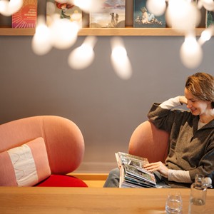 Woman sitting in an armchair and reading a book