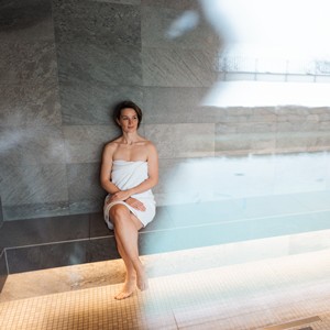 Woman sitting in a sauna