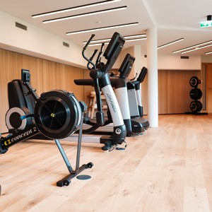 Fitness room with cardio equipment.