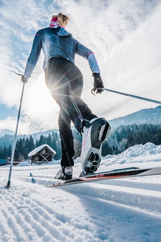 Woman cross-country skiing in a wintry landscape