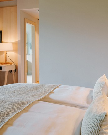 Our rooms are more than just rooms Double bed and desk in a hotel room