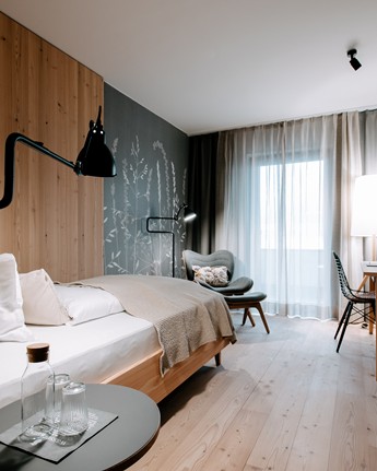 Hotel room with single bed, armchair and desk