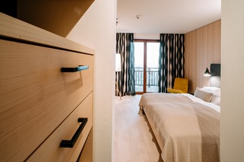 Chest of drawers & double bed in the hotel room
