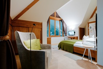Armchair and double bed in the hotel room