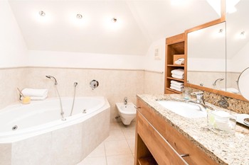 Bathroom in the hotel room with bathtub and washbasin