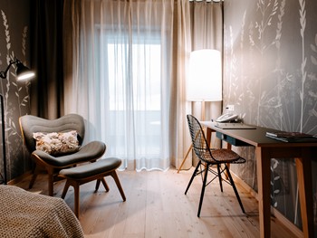 Alleine reisen, ohne Abzug beim Komfort Gemütliche Sitzecke und Schreibtisch im Hotelzimmer