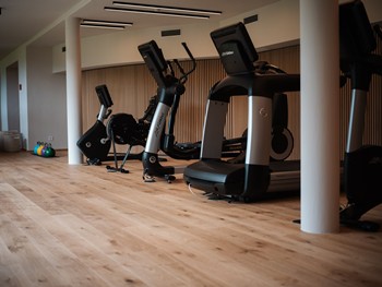 Fitness room with cardio equipment.