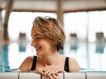 Laughing woman at the edge of the indoor pool
