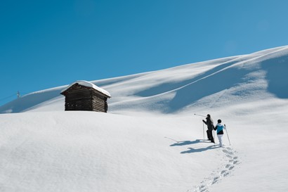 Two people snowshoeing in deep snow