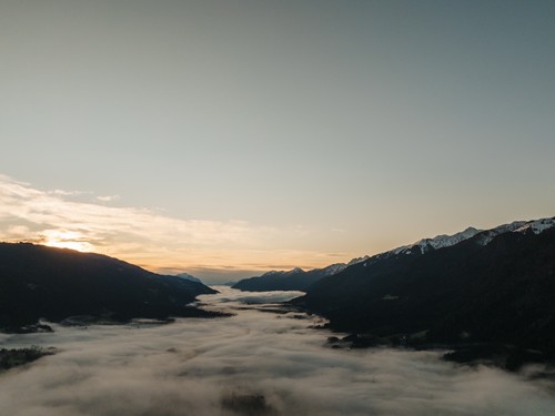 Mountainous landscape before sunrise, fog in the valley