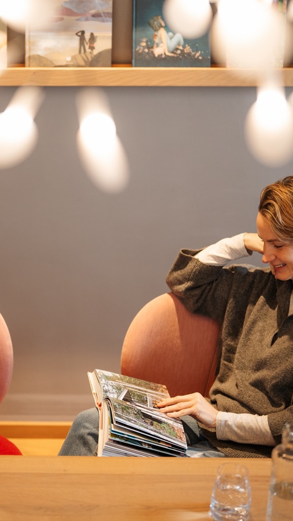 Woman sitting at a table reading a book