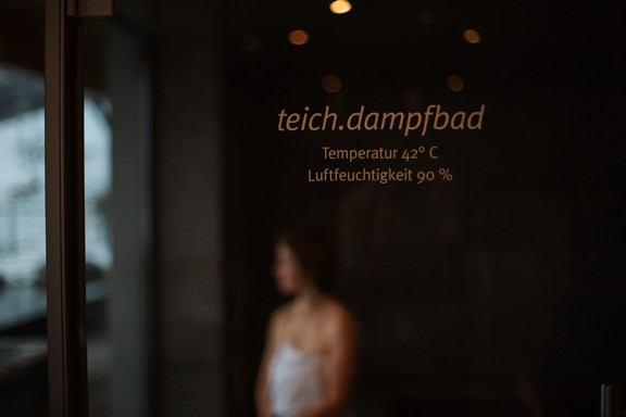 Blurred view of a woman through a glass door
