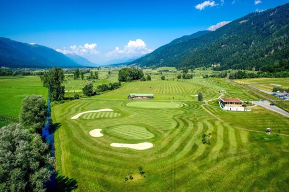 Golf course from above surrounded by mountains
