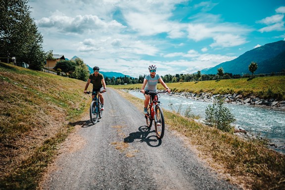 Cyclists on a path along the river