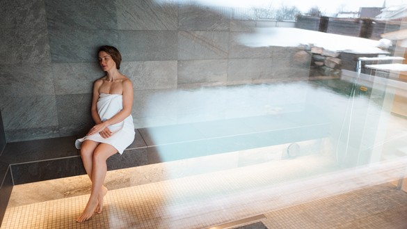 Woman sitting in a sauna